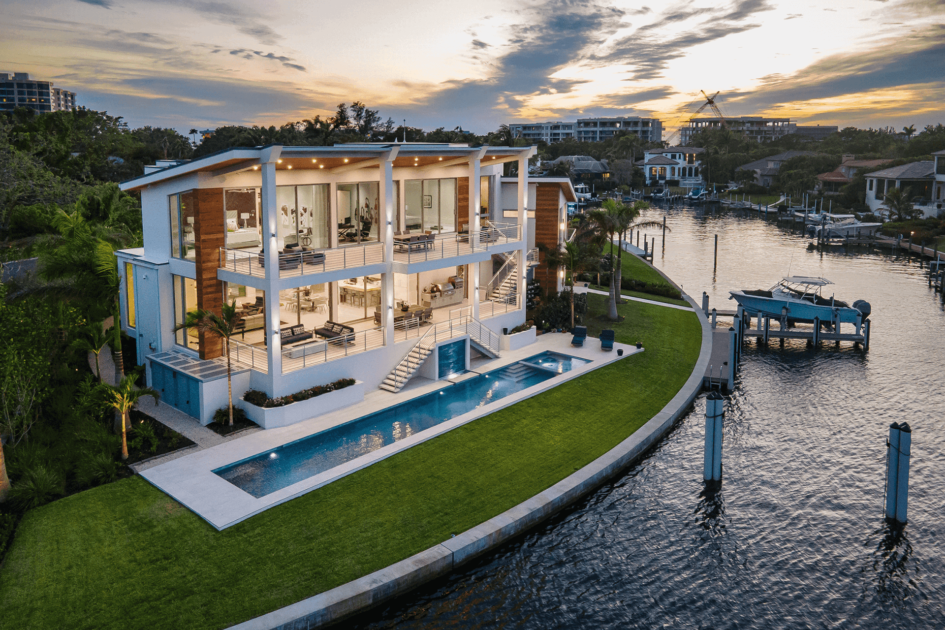 Modern waterfront home featuring expansive multi-slide glass doors.